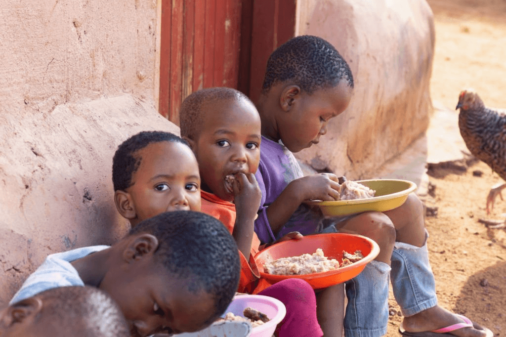African child receiving food